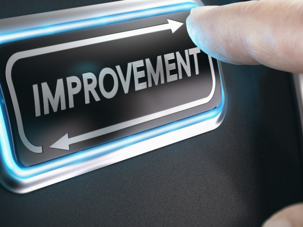 A person pressing a button that has the word 'IMPROVEMENT' on it A person pressing a button that has the word 'IMPROVEMENT' on it