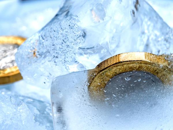 Frozen New British one pound sterling coin up close macro inside ice cubes Frozen New British one pound sterling coin up close macro inside ice cubes