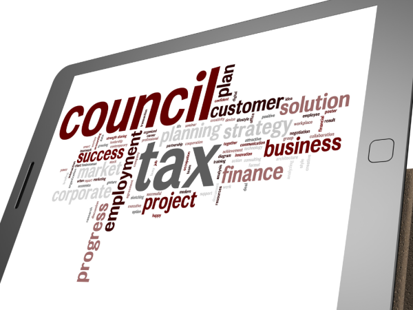 A tablet showing word art of the word 'COUNCIL TAX' surrounded by other associated words. 
