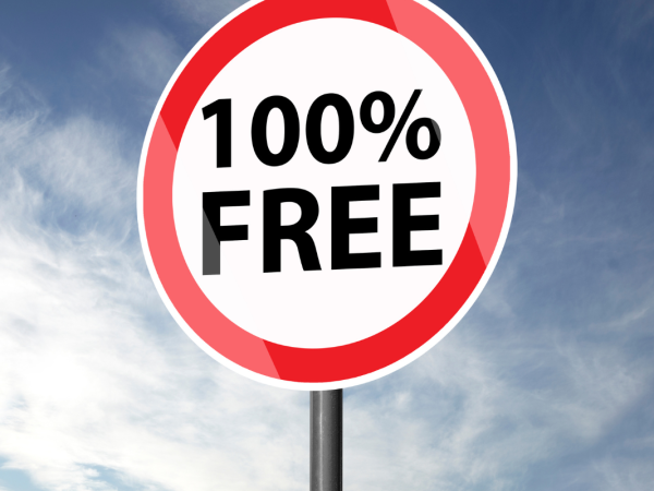 A red and white circular street sign with black text that reads '100% FREE'