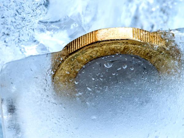 Pound coins frozen in ice