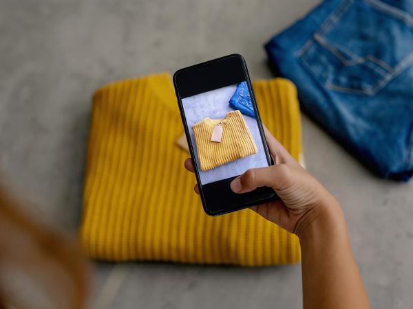 taking a picture with a mobile phone jumper with a price tag