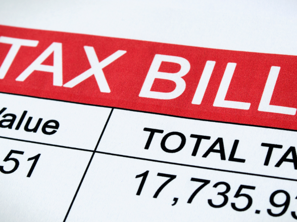 an example of a tax bill with the words 'TAX BILL' in large white text against a red background