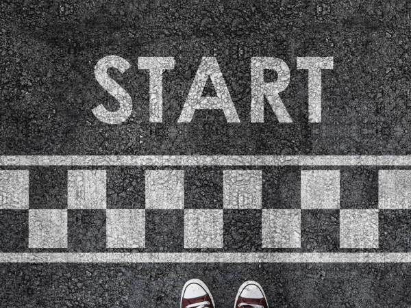 A white chequered patters painted onto tarmac with the word 'START' 