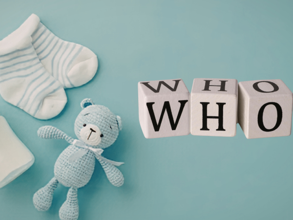Baby items against a pale background and blocks that spell out the word 'WHO' 