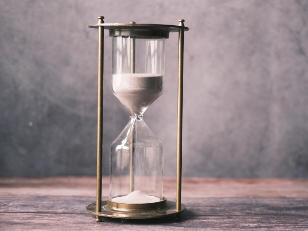 An hourglass with sand flowing through 