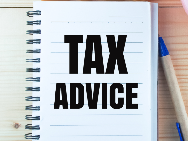a notepad with the words 'TAX ADVICE' printed on it in black text