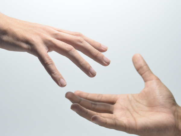 A hand reaching out to another hand