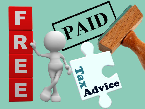A man stood up against a wall of lettered tiles spelling out the word 'FREE', a stamper that has printed the word 'PAID' and a jigsaw piece with the words 'TAX ADVICE' printed on it.