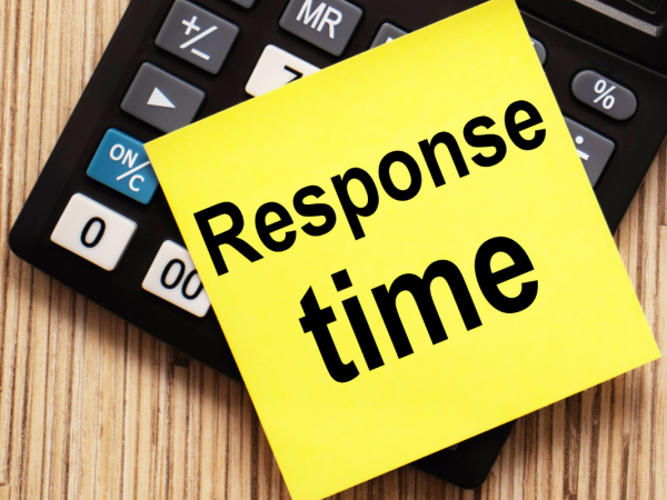 A calculator with a piece of yellow card on top, the card reads the words 'RESPONSE TIME' 