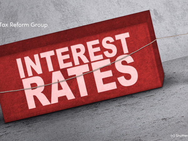 Illustration of two people pulling a block with the words interest rates on it