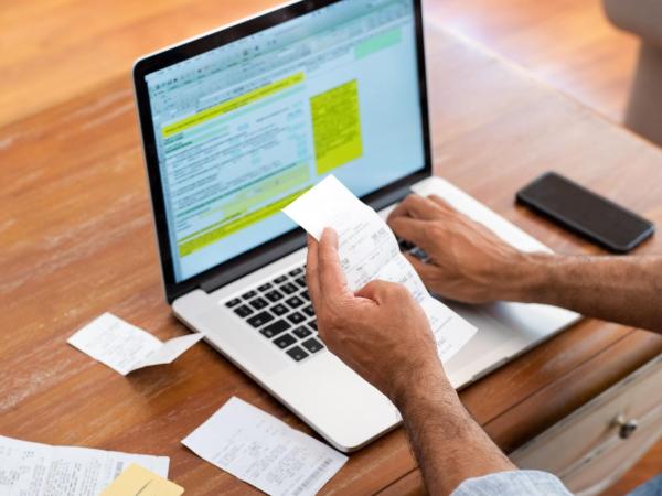man checking expenses to claim tax back online