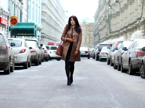 Woman walking in the middle of a road.