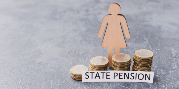 wooden figure of a person stood besides a stack of coins with a typed sign that reads 'state pension' wooden figure of a person stood besides a stack of coins with a typed sign that reads 'state pension'