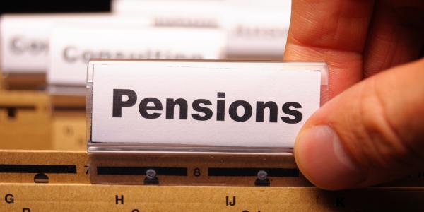an open filing cabinet with a folder named 'PENSIONS' an open filing cabinet with a folder named 'PENSIONS'