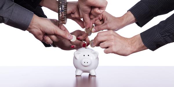 various people putting money into a piggy bank