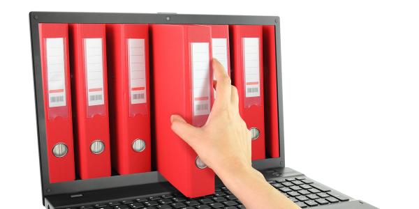 A laptop screen showing various red folders, a person is reaching into the screen to retrieve one of the files. A laptop screen showing various red folders, a person is reaching into the screen to retrieve one of the files.