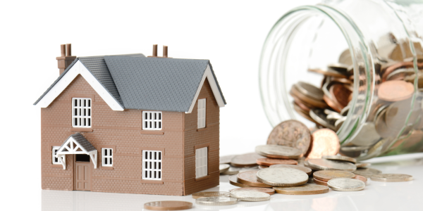 a family home next to a large jar of coins spilling out, signifying the cost of living a family home next to a large jar of coins spilling out, signifying the cost of living
