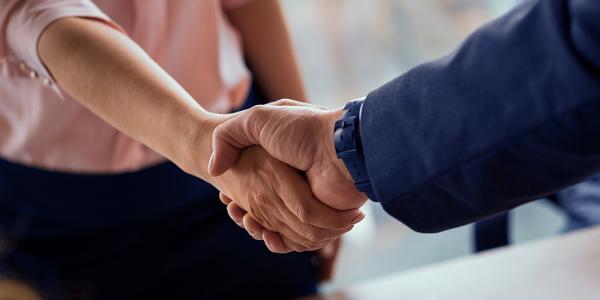 two people shaking hands. 