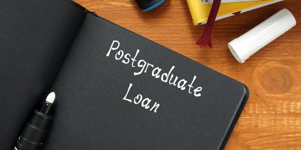 a black notebook with white writing inside. writing says 'POSTGRADUATE LOAN' a black notebook with white writing inside. writing says 'POSTGRADUATE LOAN'