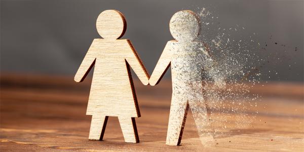 wooden figures of a man and woman, the man is fading into dust wooden figures of a man and woman, the man is fading into dust