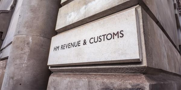 an image of the outside of HMRC office building. The words 'HM REVENUE & CUSTOMS' can be seen on the stone wall an image of the outside of HMRC office building. The words 'HM REVENUE & CUSTOMS' can be seen on the stone wall