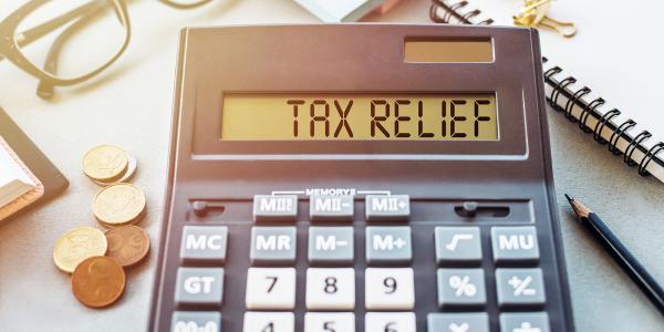 a calculator with the words 'TAX RELIEF' typed on it. a calculator with the words 'TAX RELIEF' typed on it.