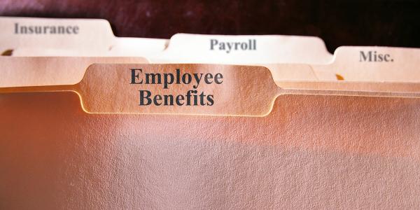 folders in a filing cabinet, the front folder reads 'EMPLOYEE BENEFITS' others behind this read 'INSURANCE', 'PAYROLL' and 'MISC'.