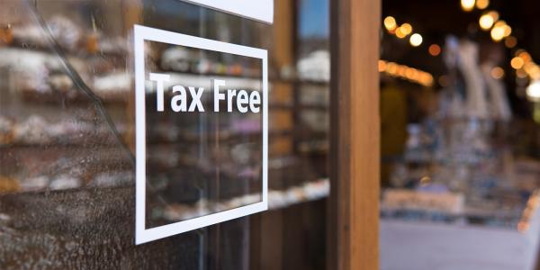 an open glass door with the words 'TAX FREE' written on it in white text