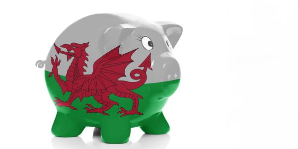 a ceramic piggy bank on a white background decorated with the Welsh flag a ceramic piggy bank on a white background decorated with the Welsh flag