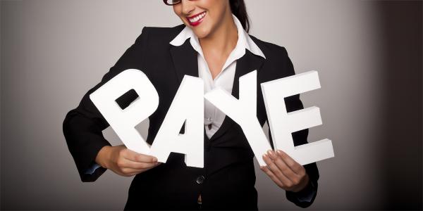 A person holding large white letters to spell the word 'PAYE' 