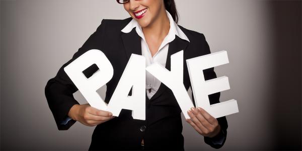 A person holding large white letters to spell the word 'PAYE' A person holding large white letters to spell the word 'PAYE'
