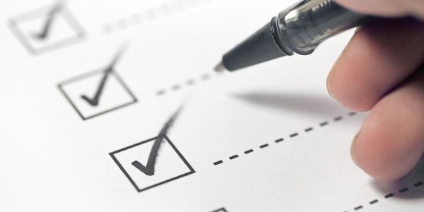 a person ticking a checklist a person ticking a checklist