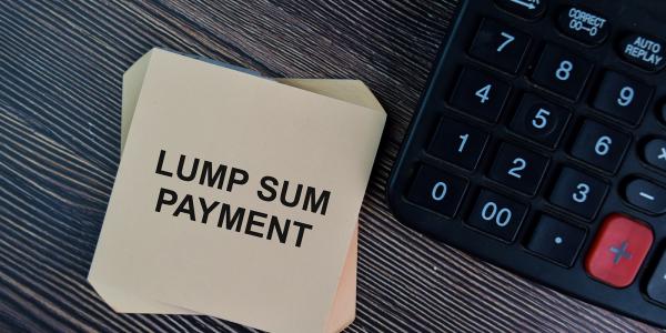 a pile of post-it notes, the top one reads 'LUMP SUM PAYMENT' in back ink. next to this is a calculator a pile of post-it notes, the top one reads 'LUMP SUM PAYMENT' in back ink. next to this is a calculator