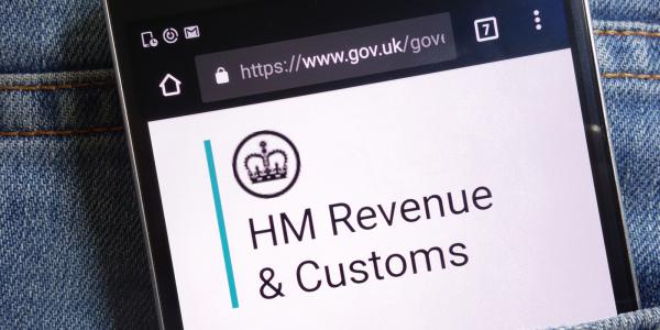 a phone open on the website for GOV.UK the screen shows the 'HM Revenue & Customs' logo. 