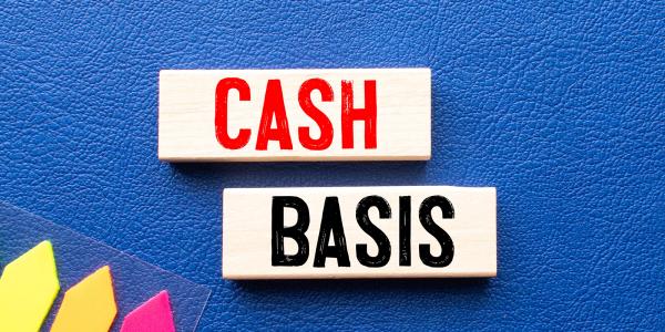 2 wooden blocks with words written on them, one saying 'CASH' and the other 'BASIS' against a blue background. 2 wooden blocks with words written on them, one saying 'CASH' and the other 'BASIS' against a blue background.