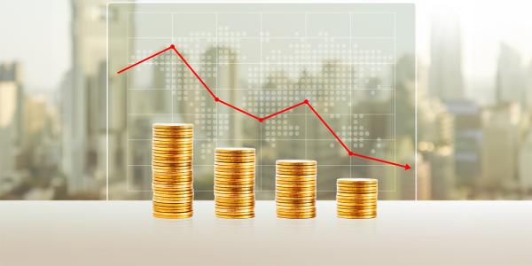 4 piles of coins getting smaller from left to right, a translucent graph sits above showing the decrease with a red line.