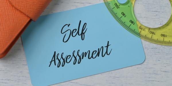 a blue card with the words 'SELF ASSESSMENT' written on it. a blue card with the words 'SELF ASSESSMENT' written on it.
