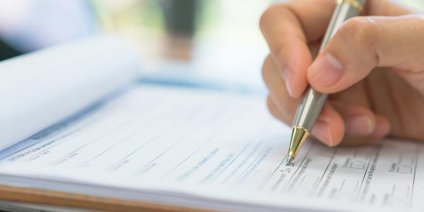 a person filling out a form a person filling out a form