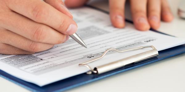 a person filling out a form a person filling out a form