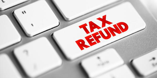 a white keyboard with the words 'TAX REFUND' on one key in red text a white keyboard with the words 'TAX REFUND' on one key in red text