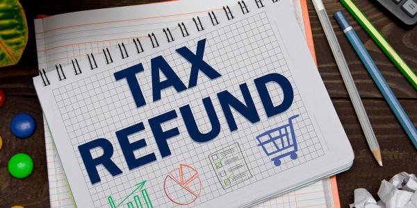 pad of paper with the words 'TAX REFUND' written on it, underneath the words are 4 small pictures of a bar chart, a pie chart, a checklist and a shopping trolley pad of paper with the words 'TAX REFUND' written on it, underneath the words are 4 small pictures of a bar chart, a pie chart, a checklist and a shopping trolley