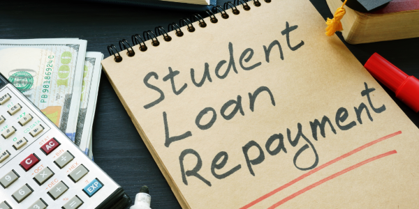 pad of paper with the words 'STUDENT LOAN REPAYMENT' written on it in black ink. pad of paper with the words 'STUDENT LOAN REPAYMENT' written on it in black ink.