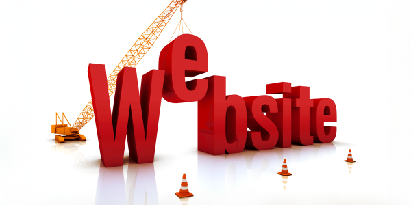 the word 'WEBSITE' being constructed by use of a crane, traffic cones can be seen around the word. the word 'WEBSITE' being constructed by use of a crane, traffic cones can be seen around the word.