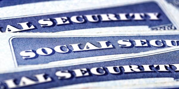 Three pieces of paper with the words 'SOCIAL SECURITY' typed on them. Three pieces of paper with the words 'SOCIAL SECURITY' typed on them.