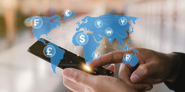 a person holding a phone, a world map is projected in the air showing many different currency symbols a person holding a phone, a world map is projected in the air showing many different currency symbols