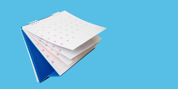a wall calendar against a blue background a wall calendar against a blue background