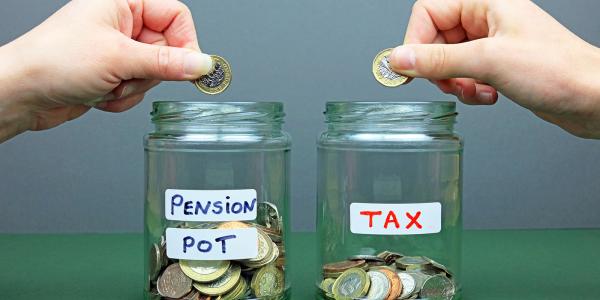 Two glass jars with stickers on them, one says 'PENSION POT' and the other says 'TAX'. A person is putting money into both jars Two glass jars with stickers on them, one says 'PENSION POT' and the other says 'TAX'. A person is putting money into both jars