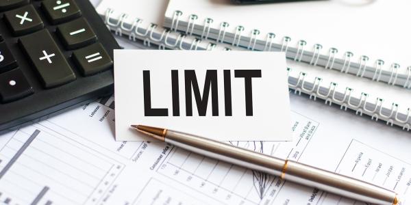 paperwork and stationary with the word 'LIMIT' typed in black text on a small card. paperwork and stationary with the word 'LIMIT' typed in black text on a small card.