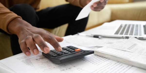 A person using a calculator. A person using a calculator.